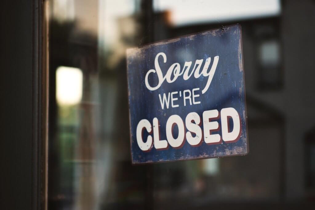 "Sorry We Are Closed" door sign, employee absent