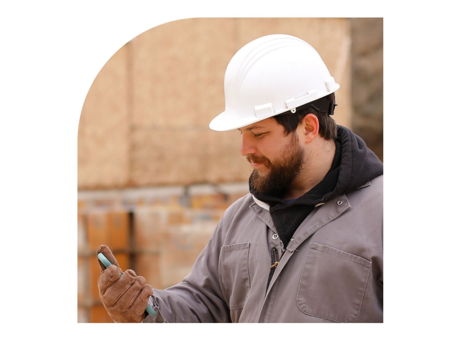 construction worker looking at phone