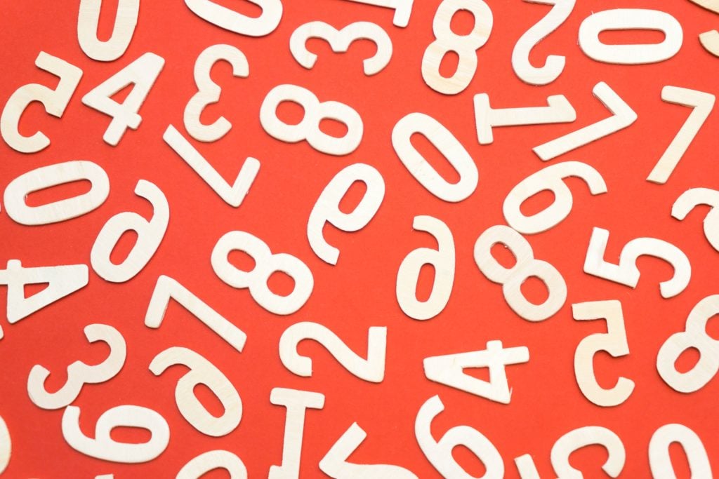 Scattered numbers on a red background