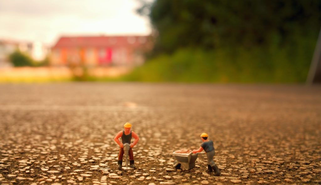 construction worker figurines in the field