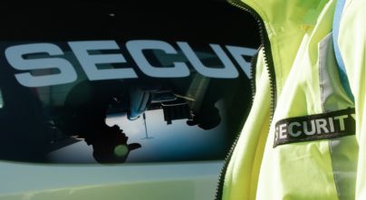 Reflection of security guards in vehicle window