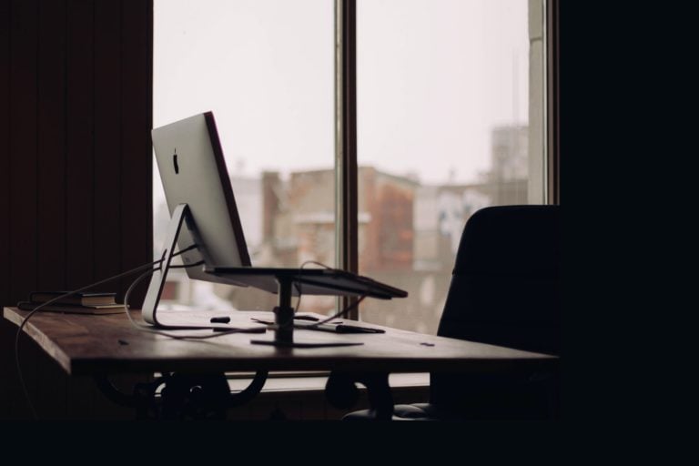 A computer stands on a desk in an empty office as the no-call no-show employee didn't show up to work