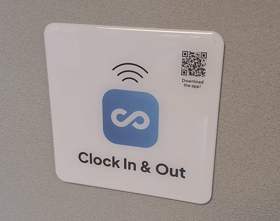 Connecteam&rsquo;s NFC tag installed on a wall for employee clock-ins.