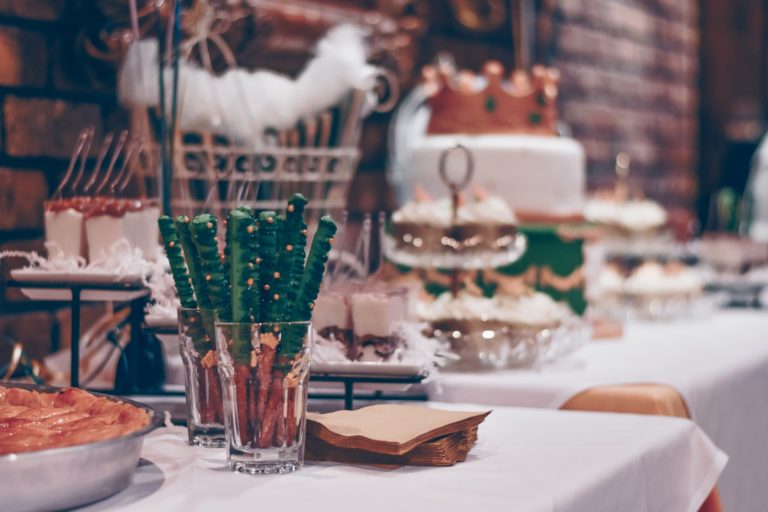 Food and snacks sit on a table ready for a successful office holiday party