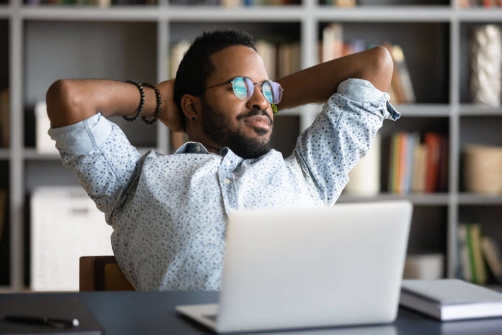 An employee sits in the office thinking about his vacation accrual