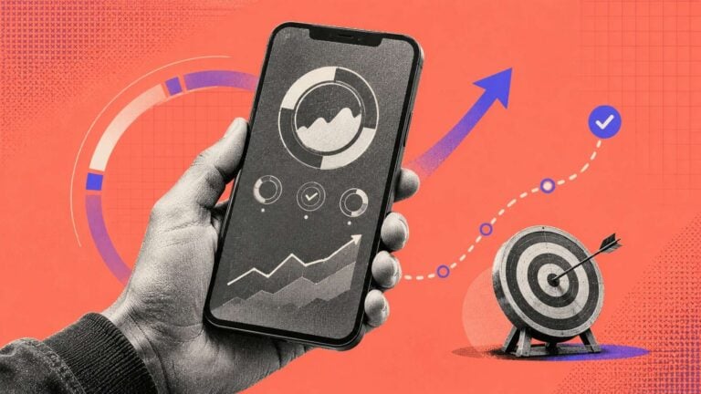 Hand holding smartphone displaying goal tracking dashboard with growth charts and target achievement graphics.