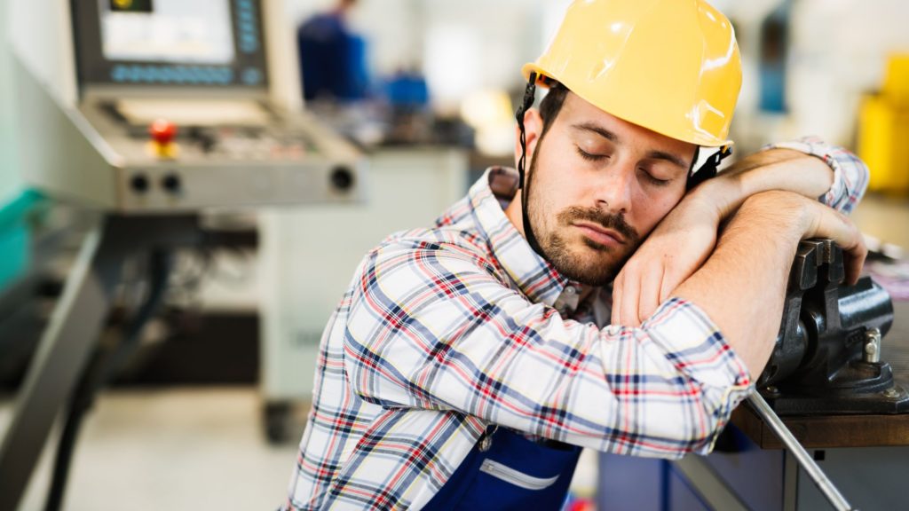 A factory worker sleeping at work