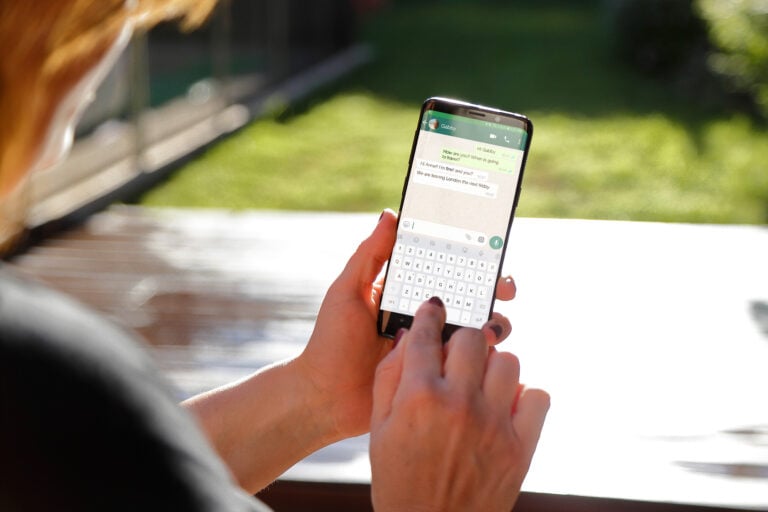 A mobile with its screen showing WhatsApp conversation