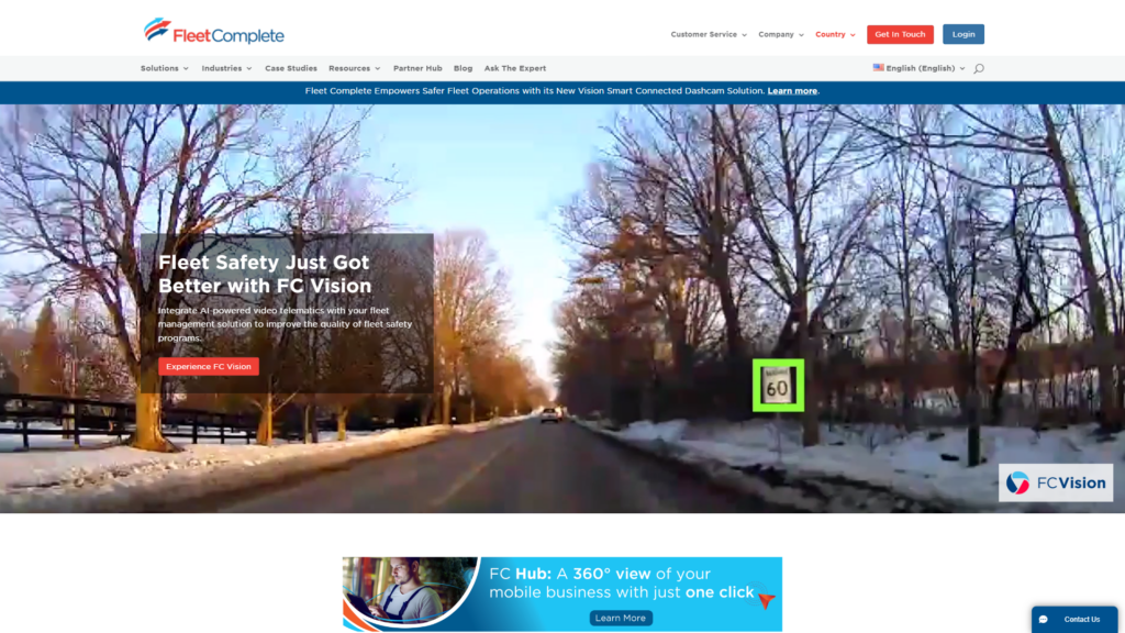 Screenshot of the Fleet Complete homepage showing a small amount of information over a background photo of a road lined by trees and snow.