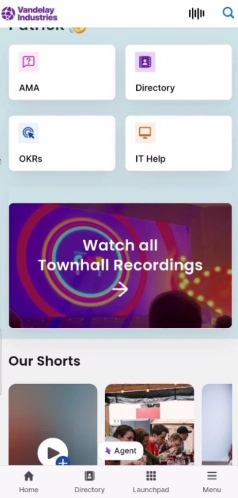 A screenshot of an employee app created using Staffbase. The dashboard includes links to the employee directory and IT help, a button to watch townhall recordings, and a slideshow of recent short videos.