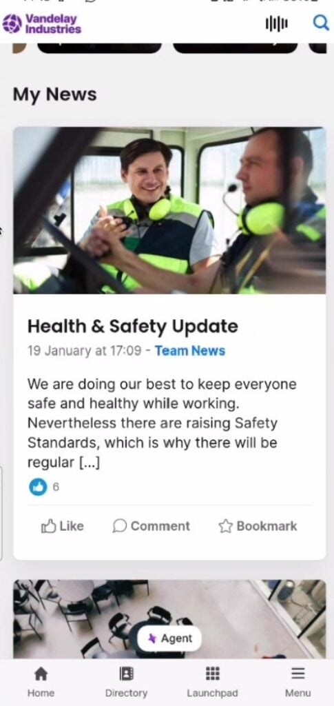 A screenshot of the news feed in Staffbase&rsquo;s employee app showing a &ldquo;Health & Safety Update,&rdquo; with 6 likes. The update itself has information in text, an image of 2 employees wearing high-visibility jackets, and the date and time of publishing. There are options to like, comment, and bookmark the post.
