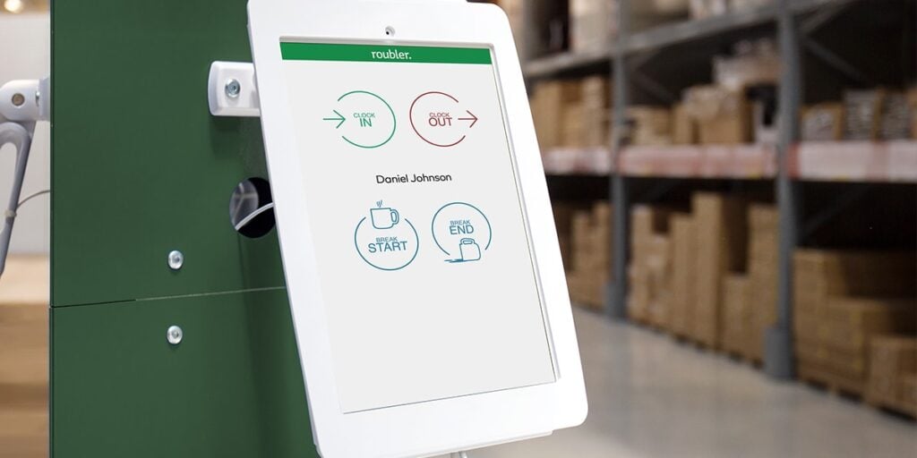 A photo of a Roubler shared kiosk installed in a warehouse