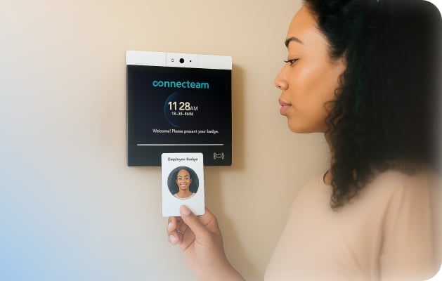Woman using employee card to clock in physically