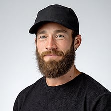A man wearing black shirt and hat