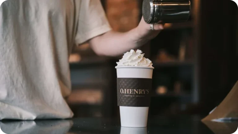 Barista preparing whipped coffee drink