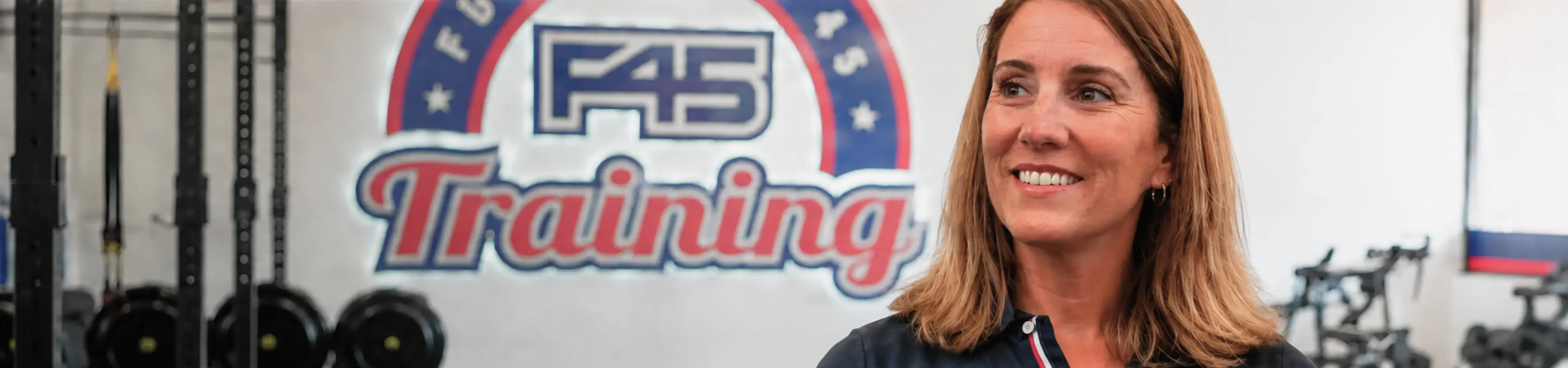 Woman sitting and speaking, with F45 Training branding.